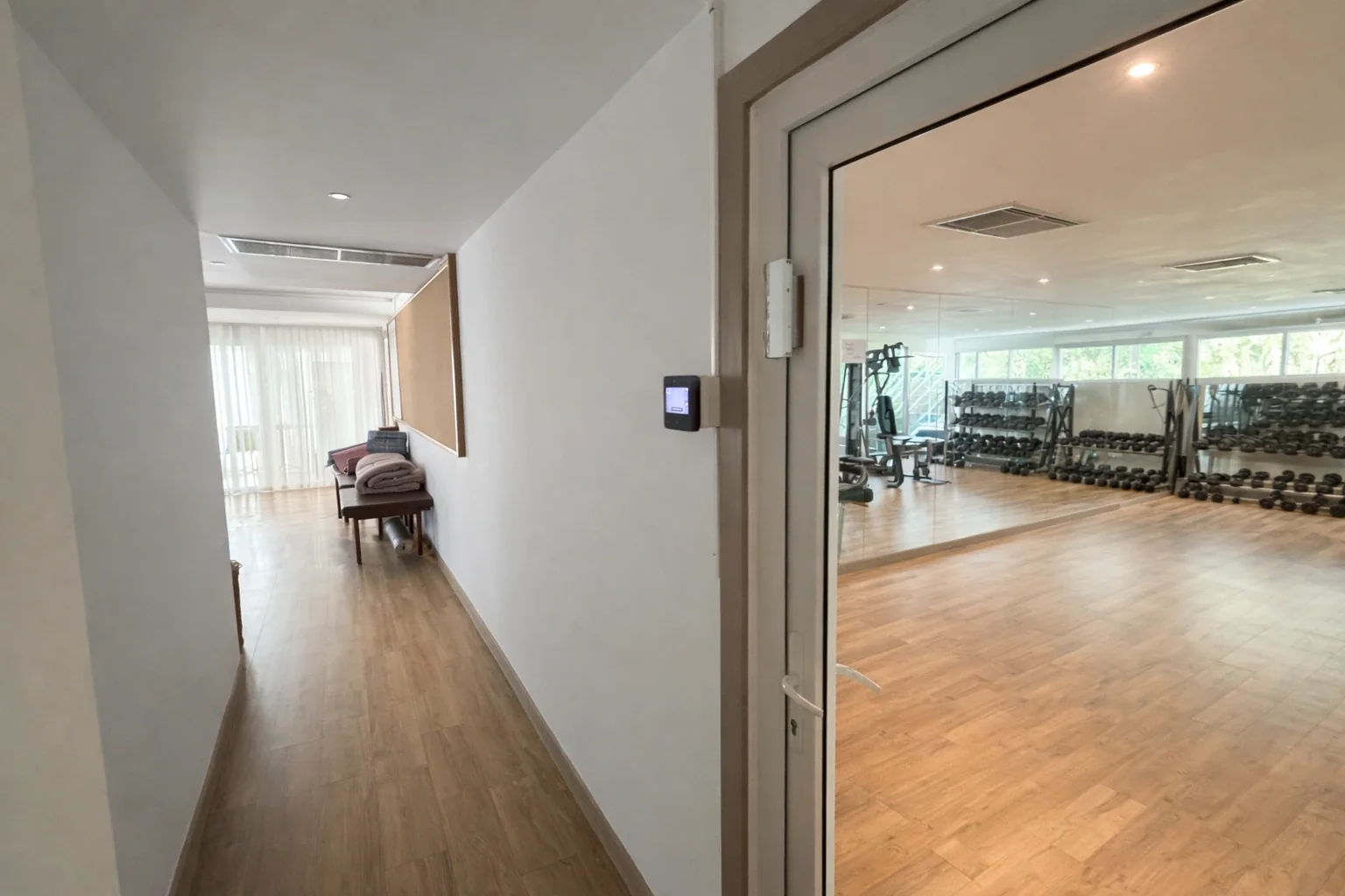 The gym entrance, with the fingerprint and face-recognition reader beside the glass door
