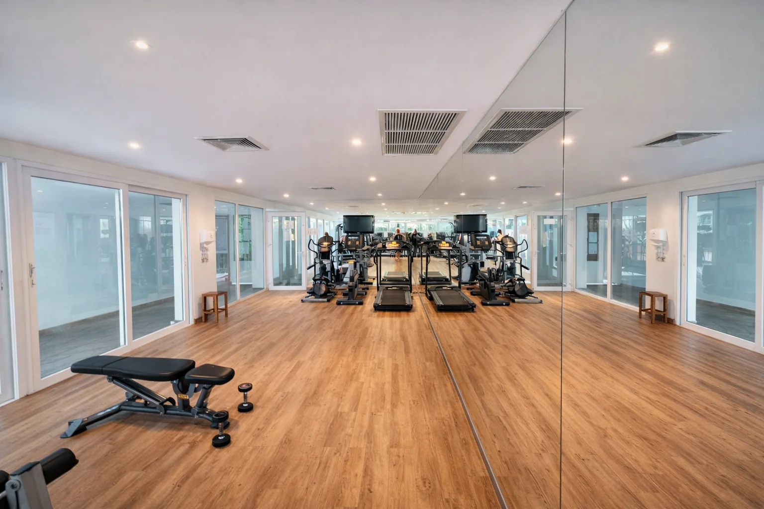 The cardio room at the Santosa gym: treadmills and cardio machines in front of a mirror wall