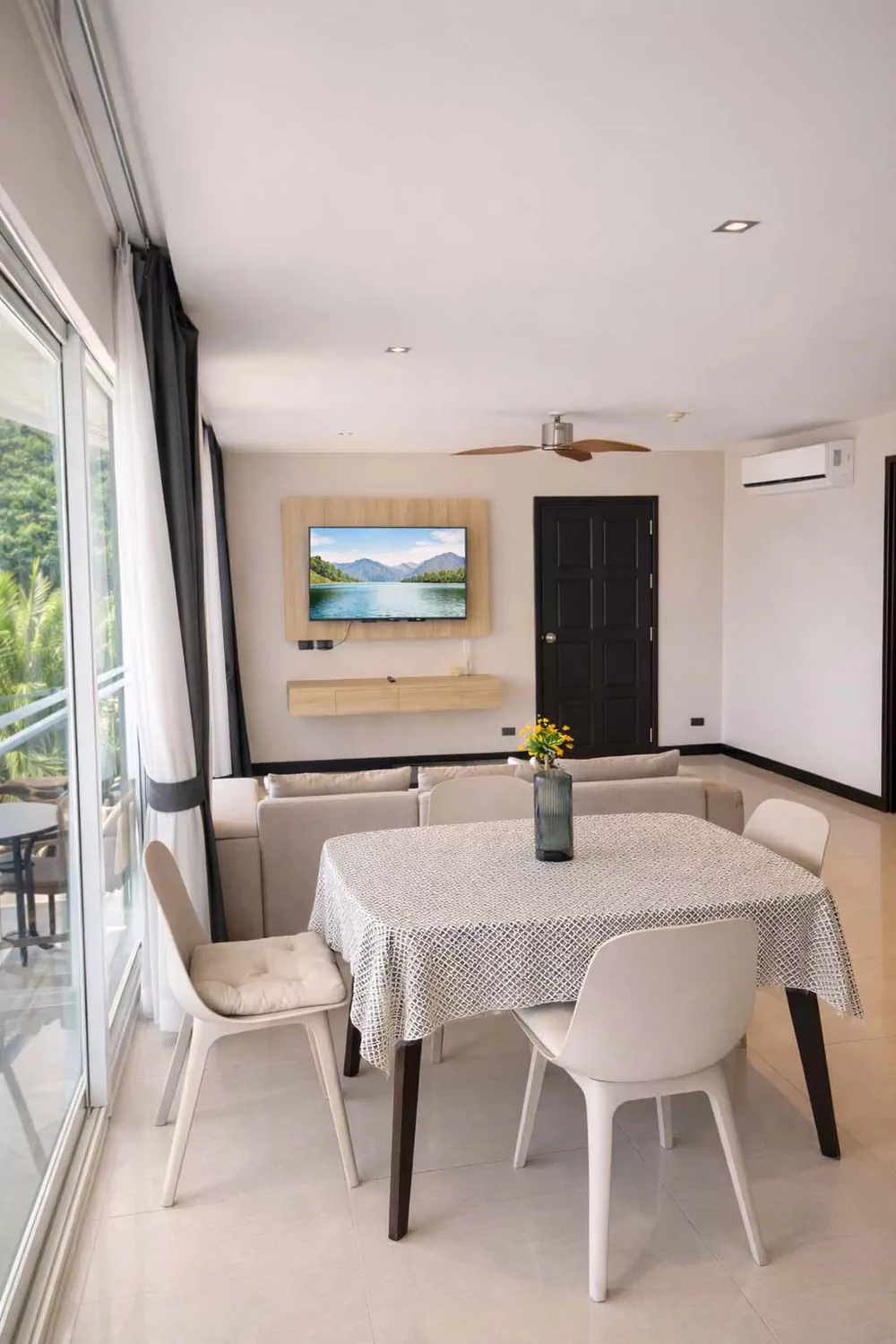 The dining corner of a sea-view room, opening onto the balcony